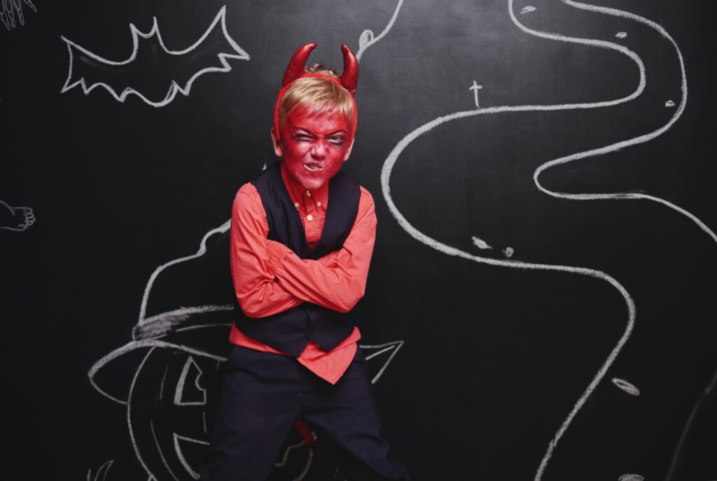 Kid celebrating Halloween in devil costume